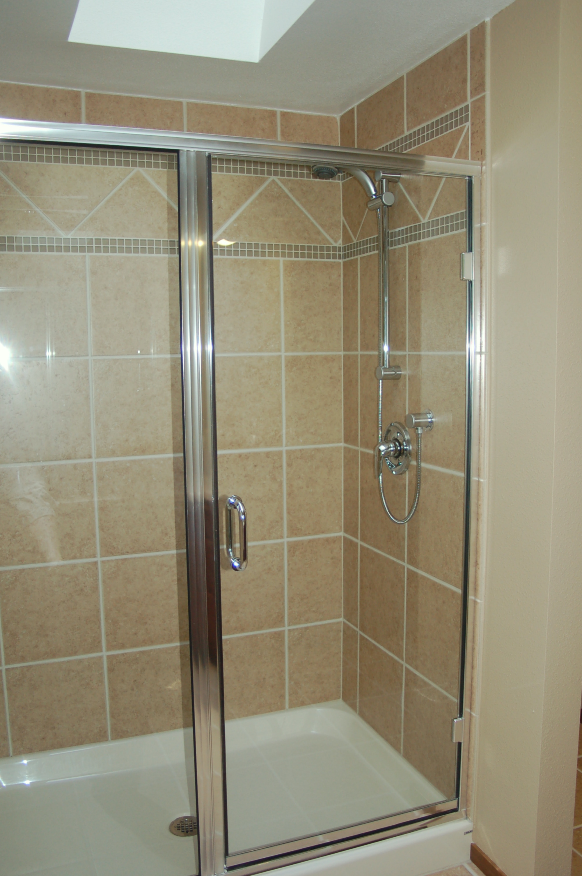 Great new tile surround and glass shower doors.