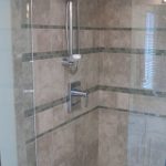 Bath remodel; Kohler Symbol valve trim with slidebar and handshower in polished chrome.