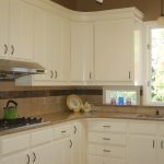 Man made stone (ESI) countertops, refaced painted cabinets, new crown moulding, tile backsplash.