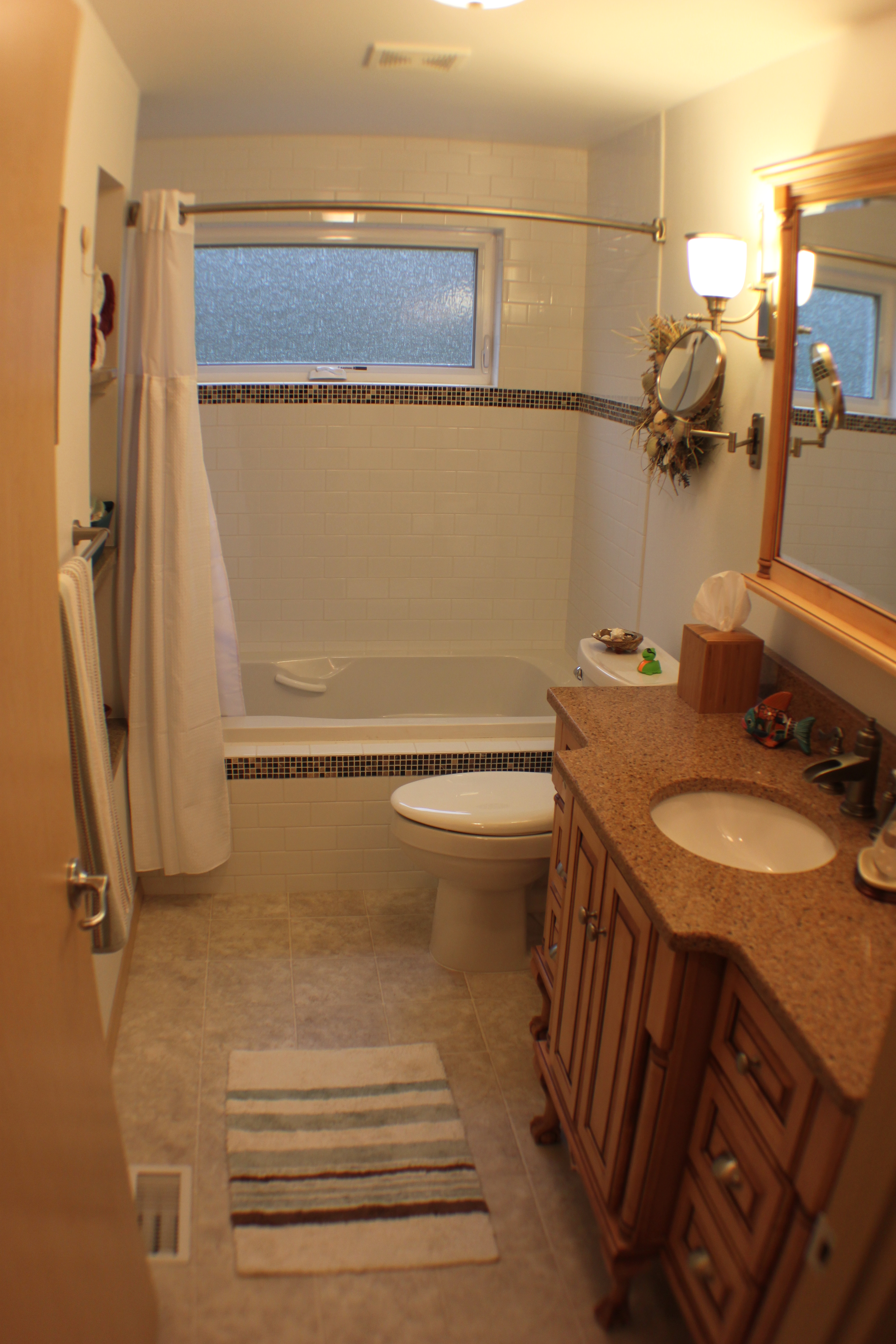 Note the curved shower rod; this is a popular option for those choosing not to go with a glass shower door.