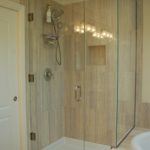 After - Small master bath; replaced tub and shower, installing tile on walls and around tub. Glass shower walls on 2 sides makes the room appear larger, Bellingham