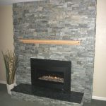 Re-faced stone fireplace surround with wood mantel