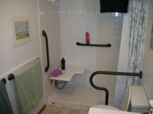 Plenty of grab bars for security. Contrasting color makes them easy to locate for low-vision client.